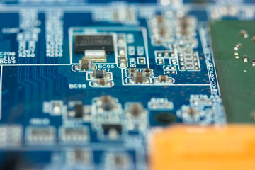 The reverse side of the colorful microboard on a blue background. Electronic board with electrical...