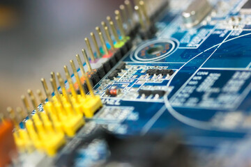 The reverse side of the colorful microboard on a blue background. Electronic board with electrical...