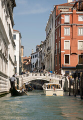 Ships sailing under the bridge with walking tourists