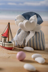 sweet food and a boat at  the seaside.
still life with sweet almonds and a boat at the seaside. italian food to celebrate wedding and newborn. - 409487348