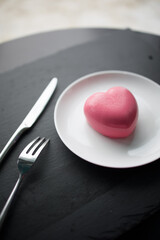 pink heart-shaped mousse cake on a plate