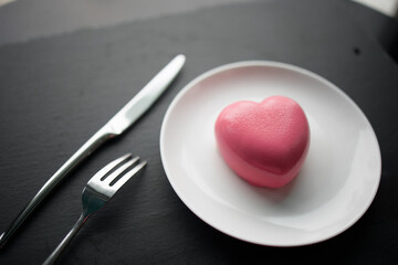 pink heart-shaped mousse cake on a plate