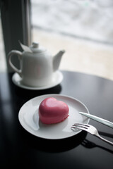 pink heart-shaped mousse cake on a plate