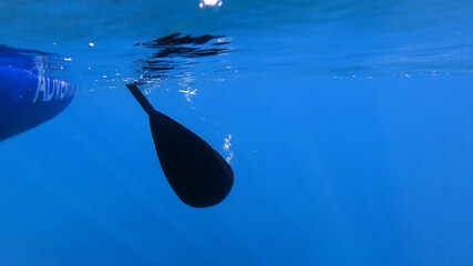 Side view of rowing oar underwater