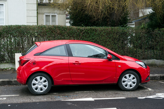 Mulhouse - France - 30 January 2021 - Rear view of red Opel Corsa parked in the street, Opel is the popular brand of german cars
