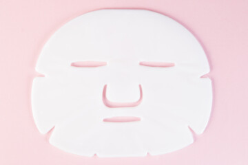 White beauty face mask on pink background