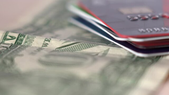 Putting Plastic Cards On Top Of Dollar Bill. Macro. Concept: Replacing Cash Payments with New Electronic Systems of Contactless Payments