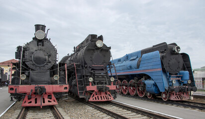 Naklejka premium Steam locomotives at railway station