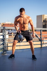 Fototapeta premium Man working out with kettle-bell.