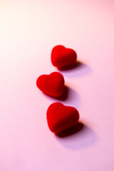 Valentine's Day. A red heart lies on a pink surface. Heart on a pink background. Love. 
