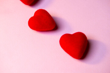 Obraz premium Valentine's Day. A red heart lies on a pink surface. Heart on a pink background. Love. 