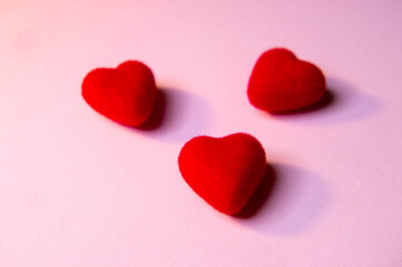 Valentine's Day. A red heart lies on a pink surface. Heart on a pink background. Love. 
