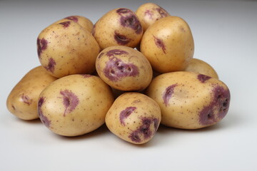 Group of potatoes on a white background. Farmer crops for sale in the market.