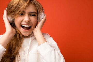 Portrait photo shot of attractive emotional positive young blonde woman wearing white hoodie...