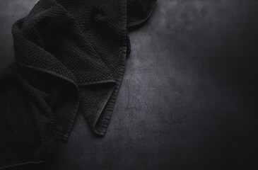 black towel on dark concrate moody background