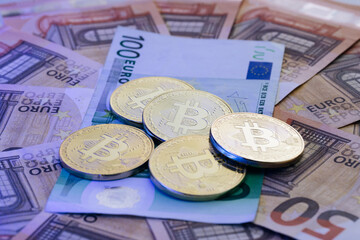 Euro banknotes. Euro bills. Coin with symbol of cryptocurrency of bitcoin lies on real banknotes of European Union, euro, new money, exchange of digital money for euro, gold coin, new economy.