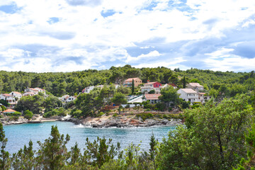 Fototapeta na wymiar Beautiful Adriatic sea in Croatia, Hvar, small village,blue lagoon, coast, green pines, trees in summer. Mudri Dolac, Basina bay. Mudri Dolac, Basina bay