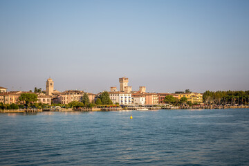 Fototapeta premium The pier and promenade of Sirmione on Lake Garda. Autumn evening. Lombardy, Italy