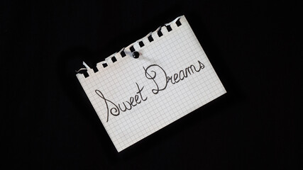 Hand written message on a ripped notebook sheet, "Sweet dreams"