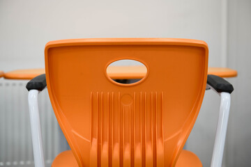 Modern bright school / office furniture - orange armchair.
