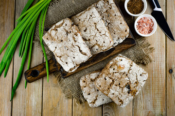 Homemade rye bread sandwich on a wooden board on a dark background. Rye bread top view