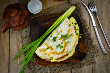 Rich breakfast: fried eggs with sausage in pita bread. Sandwich with fried eggs and sausage
