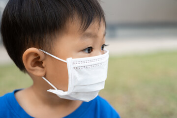 close up asian little boy wearing protect face mask