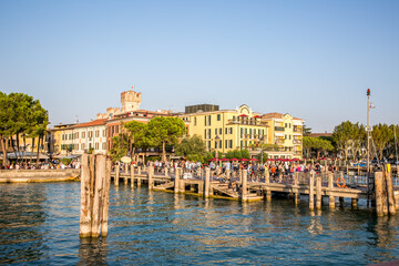 The pier and promenade of Sirmione on Lake Garda. Autumn evening. Lombardy, Italy