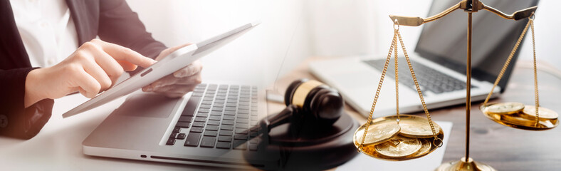 Justice and law concept.Male judge in a courtroom with the gavel, working with, computer and...