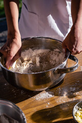 close-up of bakery production making bread with flour eggs rolling pin or rolling pin oil on wooden base background green field with sun in vacations cordoba argentina