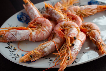 Fresh and delicious seafood, cooked shrimps. Whole cooked tiger prawn on dish.Selective focus.