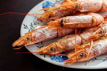 Fresh and delicious seafood, cooked shrimps. Whole cooked tiger prawn on dish.Selective focus.