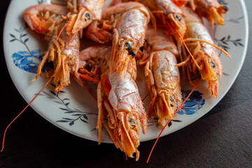 Fresh and delicious seafood, cooked shrimps. Whole cooked tiger prawn on dish.Selective focus.