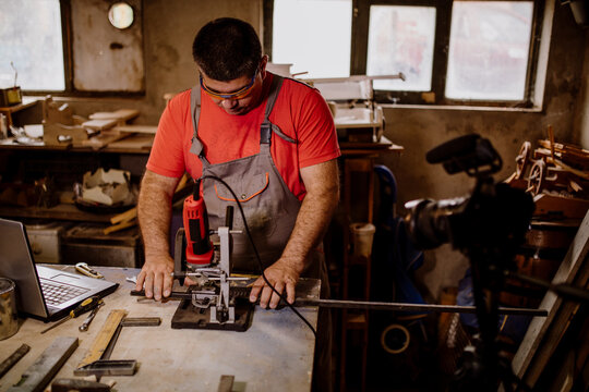 Man working in workshop - Powered by Adobe