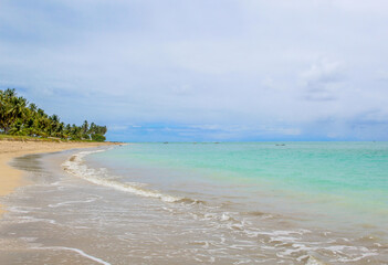 Obraz premium Praia com água cristalina e nuvens no céu