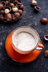 healthy natural  macadamia nuts dessert and coffee served at black table.food  and wellness concept