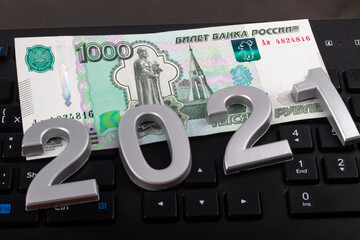 close-up. Black background. on it are numbers 2021 and a bill of 1000 rubles. Russia.