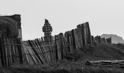 Vendée, France; January 29, 2021: black and white photo of a young walker with headphones on the ears on the corniche of Saint Hillaire de Riez.