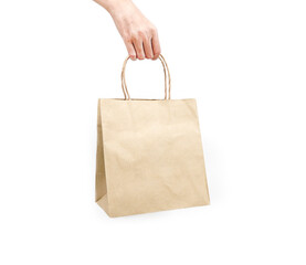 A woman holding a recycled paper bag on a white background.