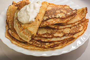  Photo Delicious thin Pancakes With Sour Cream. Traditional Russian Dish. Restaurant Serving.