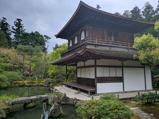 KYOTO, JAPAN - APRIL 5, 2018: Park area at Ginkaku-ji Temple - Silver Pavilion in Kyoto. On the territory of the park there is the Silver Pavilion temple, next to it there is a pond with lined stones.