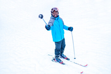 afro american man in blue jacket run ski outdoors in freeze forest