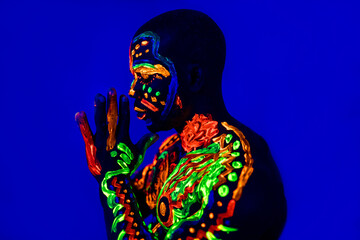 afro american man posing in studio shot with UV light