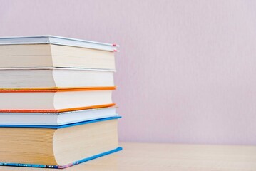 Old books on bookshelf on simple backdrop. Copy space for your text.