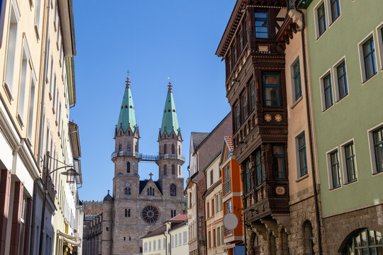 Street with house facades and view to the town church in Meiningen