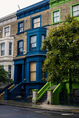 Colorful English houses facades in Notting Hill London on a cloudy day