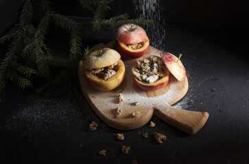 prepared for baking stuffed apples on a black background