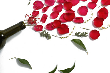 rose petals and ornamental plants are bursting from the neck of the bottle. womens day, floral wine...