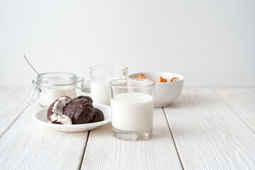 Fresh milk, marshmallows and bread flakes on a white background. Side view, with space to copy. The concept of food products.