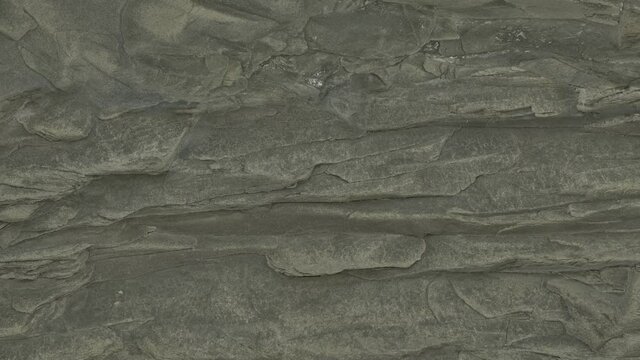 Sliding along the cliff. The beauty of gray stone.